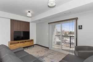 Family Suite, Balcony | Living area | 55-inch Smart TV with cable channels