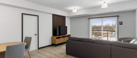 Family Suite, Balcony | Living area | 55-inch Smart TV with cable channels