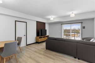 Family Suite, Balcony | Living area | 55-inch Smart TV with cable channels