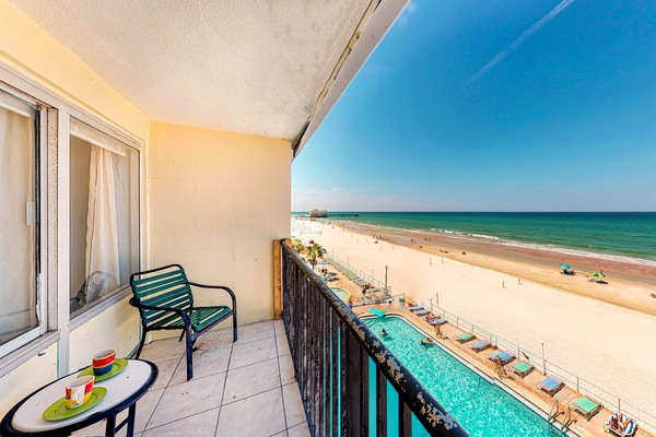 Private oceanfront balcony overlooking the sandy beach and sparkling pool. Enjoy morning coffee, sea breezes, and stunning coastal views—perfect for a memorable beach stay just steps from the shoreline.