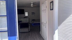 A room with a bed, dresser, ceiling fan, and a window. - Siesta Key APT On OceanW/FREE WIFI, BEACH AMENTITIES, ONSITE MANAGER, &LAUNDRY (Siesta Key)