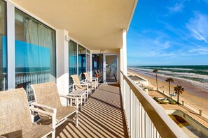 A balcony with wicker chairs and a view of the beach. - 5th-Floor Oceanfront Retreat w/ Balcony & Resort Perks (Daytona Beach)