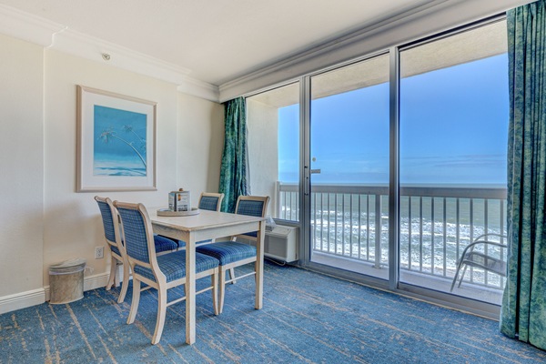 Enjoy meals with breathtaking beach views from this bright oceanfront dining nook. Floor-to-ceiling windows showcase the shoreline, creating the perfect setting for your relaxing beach stay.