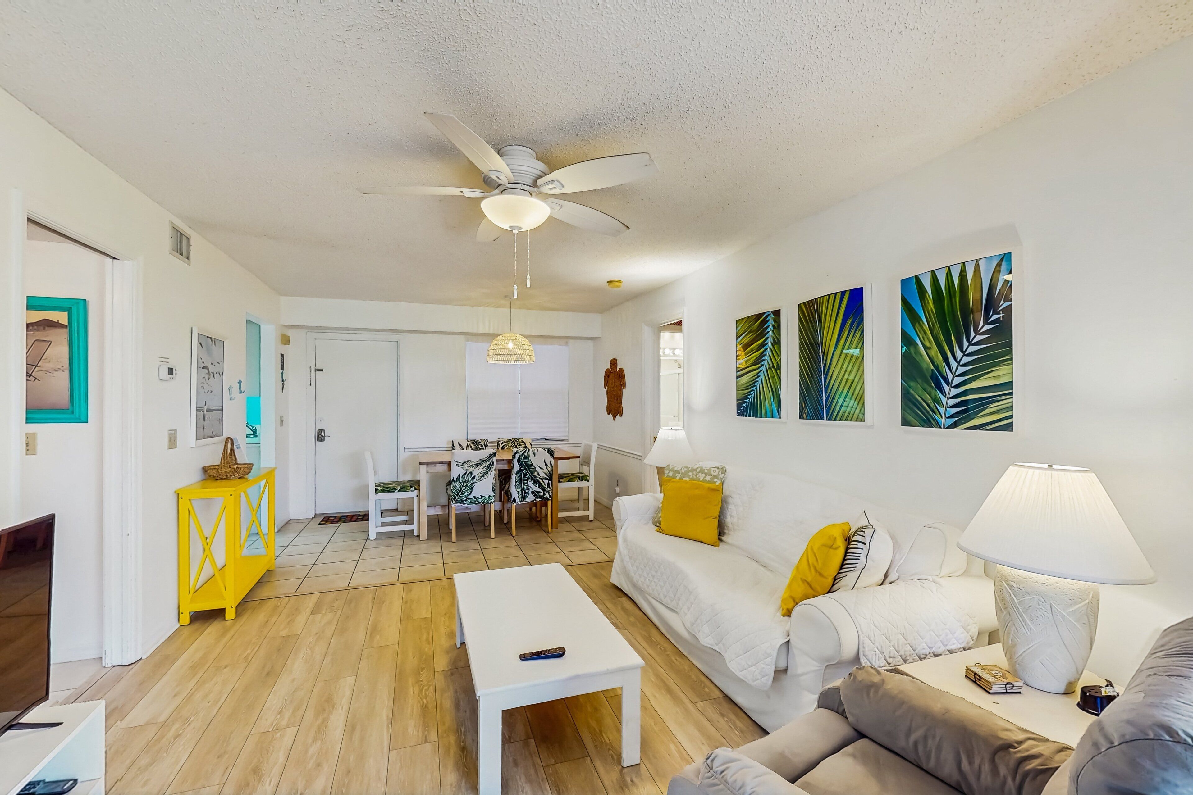 Enjoy a relaxing beach stay in this bright coastal condo featuring tropical décor, open living and dining space, comfy seating, and island-inspired accents—perfect for unwinding after a day in the sun and sand.