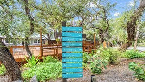 A directional signpost in a park-like setting with various labeled paths for wildlife observation. - Gulf View Escape on the Beach with Lounging Deck (Englewood)