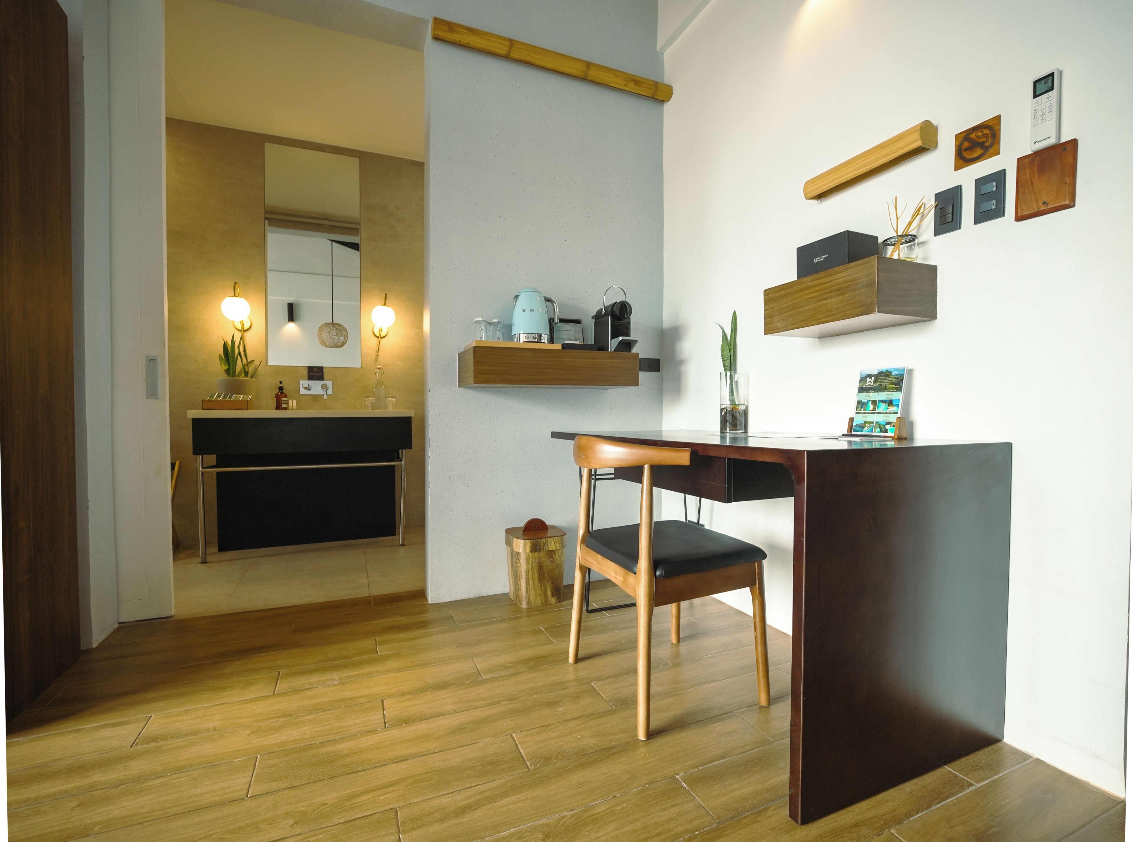 A modern kitchen with a wooden countertop, a built-in oven, and a coffee machine.