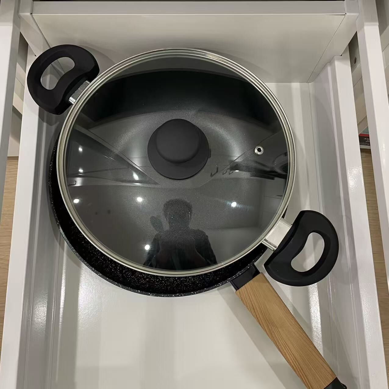 A kitchen with a stove and a pot.