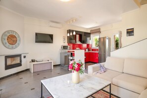 TV, fireplace, books - Sunny Spa Villa – Private Pool, Sauna, Aircon & WiFi (Hanioti)