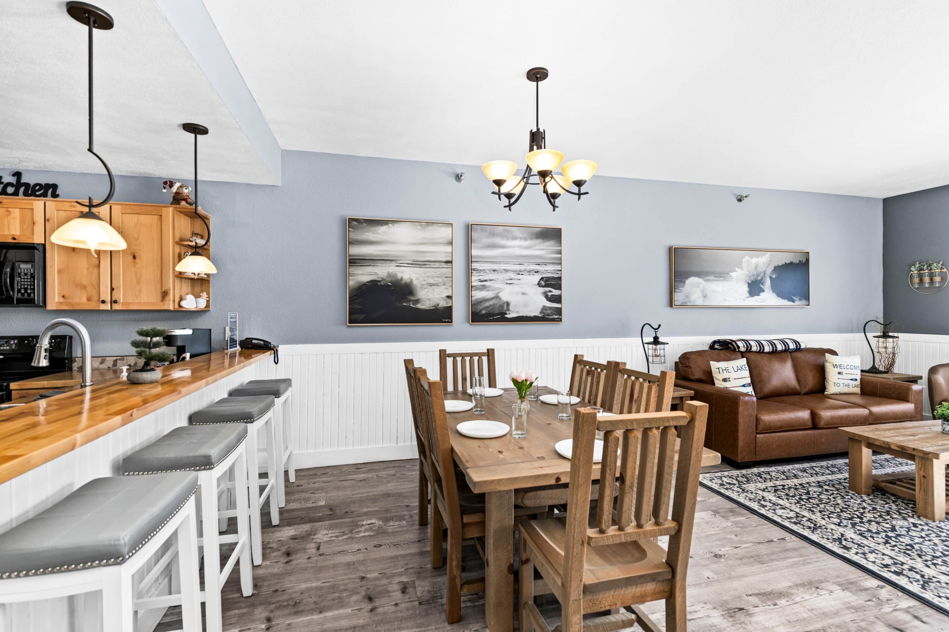 A modern kitchen with wooden cabinets, a bar area, and a dining set.