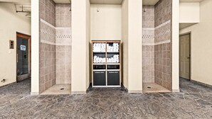 A hallway with a tiled floor and a storage unit labeled "TOWELS ONLY" in the center. - Whispering Pines Lake Views | 2 Queen Bed Studio (Two Harbors)