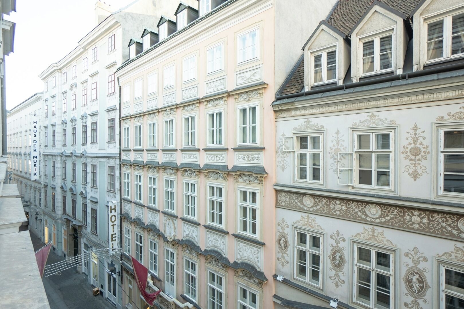 A row of historic buildings with ornate facades and multiple windows.