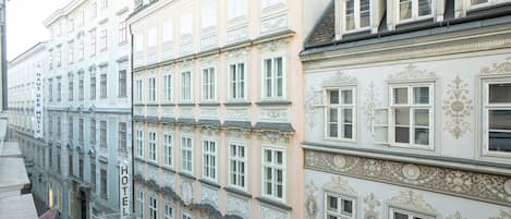 A row of historic buildings with ornate facades and multiple windows.