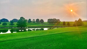 A golf course with a pond, trees, and houses in the background. - One-level Family Retreat I  Game Room I Bourbon Trail I King bed (Lebanon)