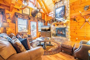 TV, fireplace - Unrivaled - Treehouse-Style Interior with Spa Bath, Hot Tub, Theater & Firepit (Sevierville)
