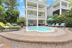 A two-story building with a pool, outdoor seating, and a covered patio area. - 29 Sandcastle Court @ Folly Field Beach | 3D Projector | Pet Friendly | Lagoon Views (Hilton Head Island)