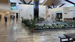 A spacious lobby with a modern design, featuring a central water feature, a staircase, and a seating area. - Luxury 3 BR w/prv Pool  Aflora (Tulum)