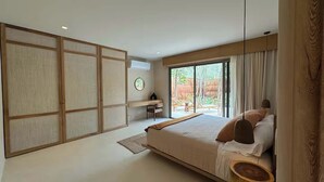 A modern bedroom with a large bed, sliding shoji screens, a desk, and a view of the outdoors. - Luxury 3 BR w/prv Pool  Aflora (Tulum)