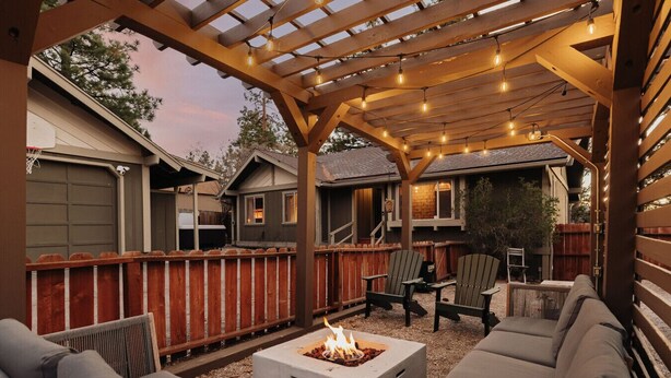 A covered outdoor patio with a fire pit, seating area, and string lights. - Three bedroom  in United States of America, Big Bear (Big Bear)