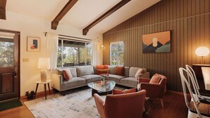 A cozy living room with a sofa, chairs, a coffee table, and a painting on the wall. - Three bedroom  in United States of America, Big Bear (Big Bear)