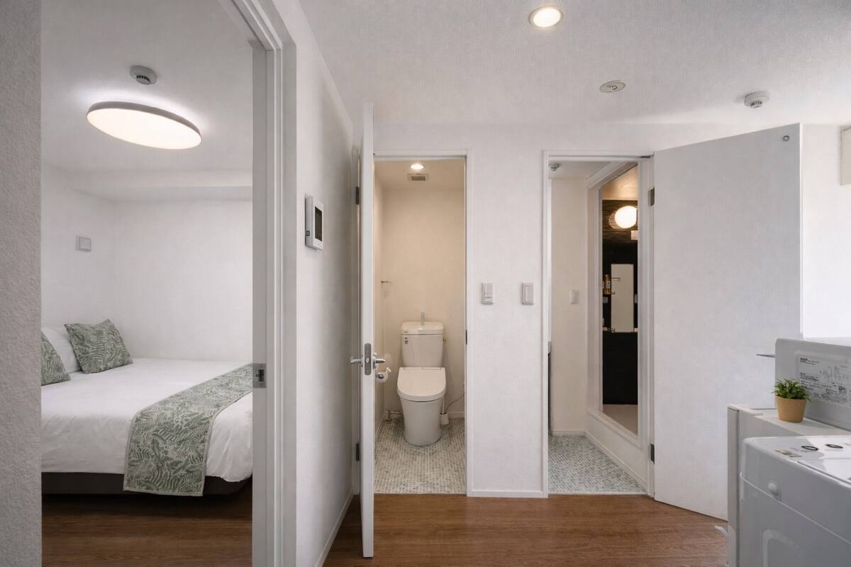A bedroom with a bed, a bedside table, and a nightstand.