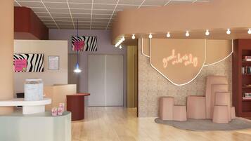 Eine moderne Hotelhalle mit einer Rezeption, einem leuchtenden Neon-Schild mit der Aufschrift "good vibes only" und einem Bücherregal voller Bücher.