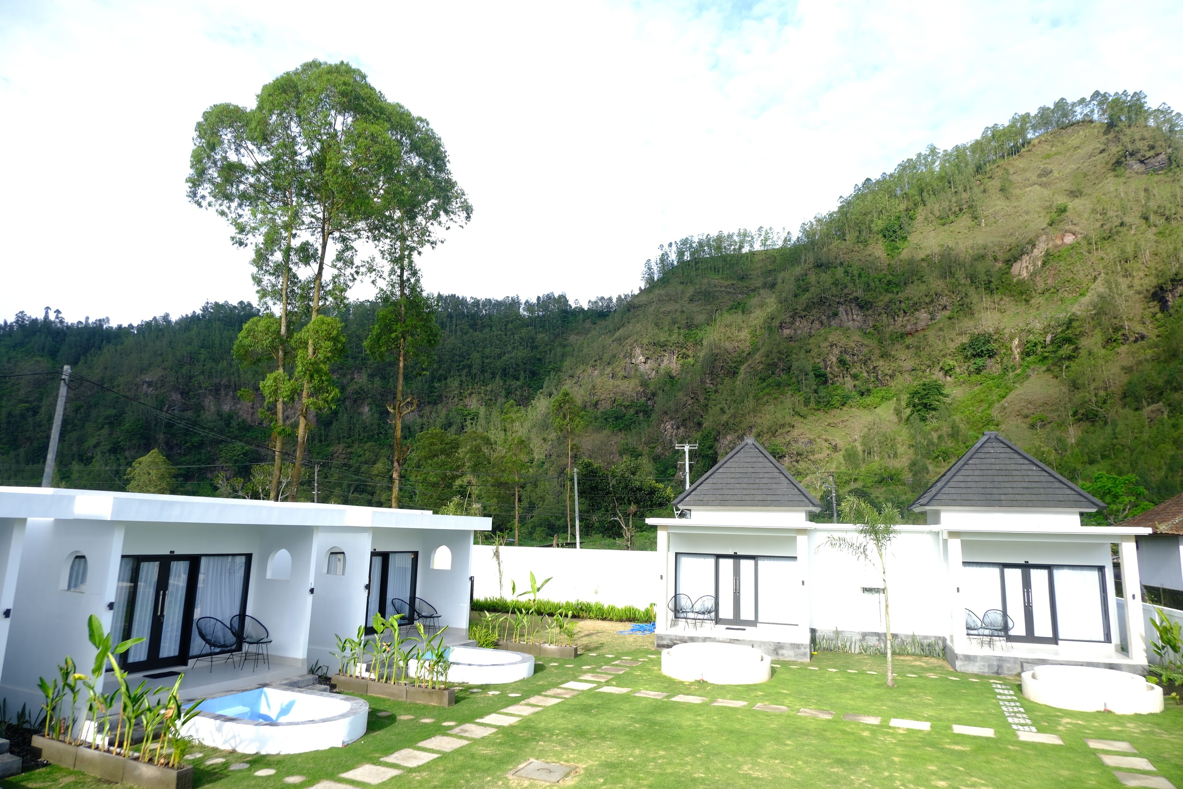 A modern villa with a pool, two guest rooms, and a well-maintained garden.