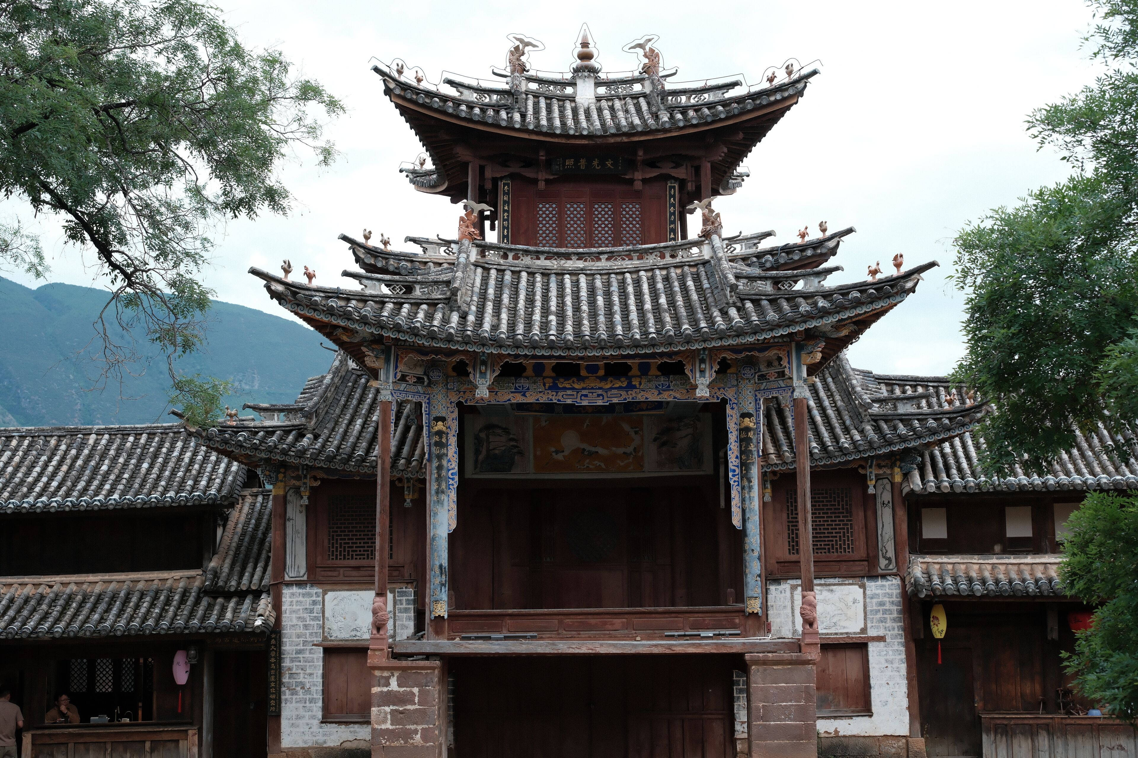 A traditional Chinese building with multiple tiers and ornate roof tiles.