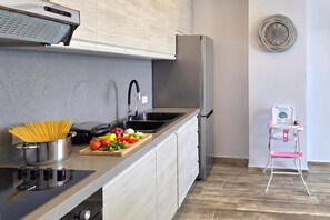 Eine moderne Küche mit Einbauherd, Spüle und Kühlschrank.