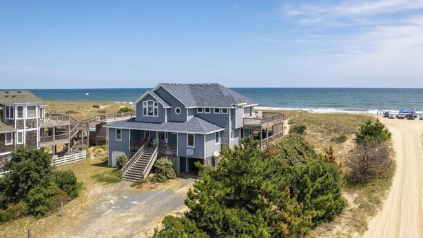 A coastal house with multiple levels, a deck, and a beach view. - Ocean front oasis full remodel hot tub heated pool Wild horses 8 bed 8 bath (Corolla)