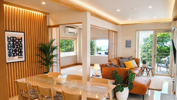 A modern living room with a glass dining table, leather sofa, and a view of the outdoors. - A Premium Okinawa Villa Stay with Sauna & Jacuzzi (nakama, Onna Village)