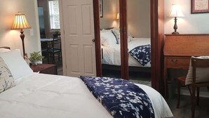 A bedroom with a bed, a wooden wardrobe, a desk, and a chair. - Newly Remodeled 2BR 2BA Home  Close to Barrington (Barrington)