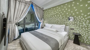 Un dormitorio moderno con una cama grande, una mesita de noche, un espejo y una ventana con cortinas.