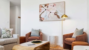 A modern living room with two sofas, a coffee table, and a floor lamp. - Ocean Views Kings Beach (Kings Beach)
