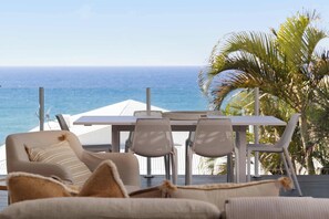 A balcony with a table and chairs, overlooking the ocean. - Thalasa Two at Sunshine Beach (Sunshine Beach)