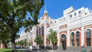 A Victorian-style building with arched windows and a brick facade, labeled as a cellar and brewery. - Mega Style Apartments Tribeca (East Melbourne)