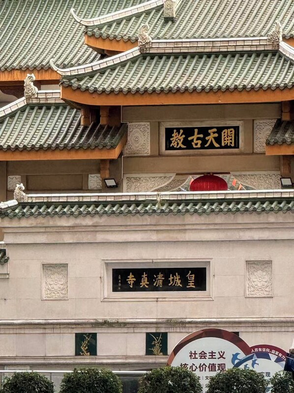 Un bâtiment traditionnel, doté d’une toiture ornée de tuiles décoratives et d’une enseigne portant des caractères chinois.