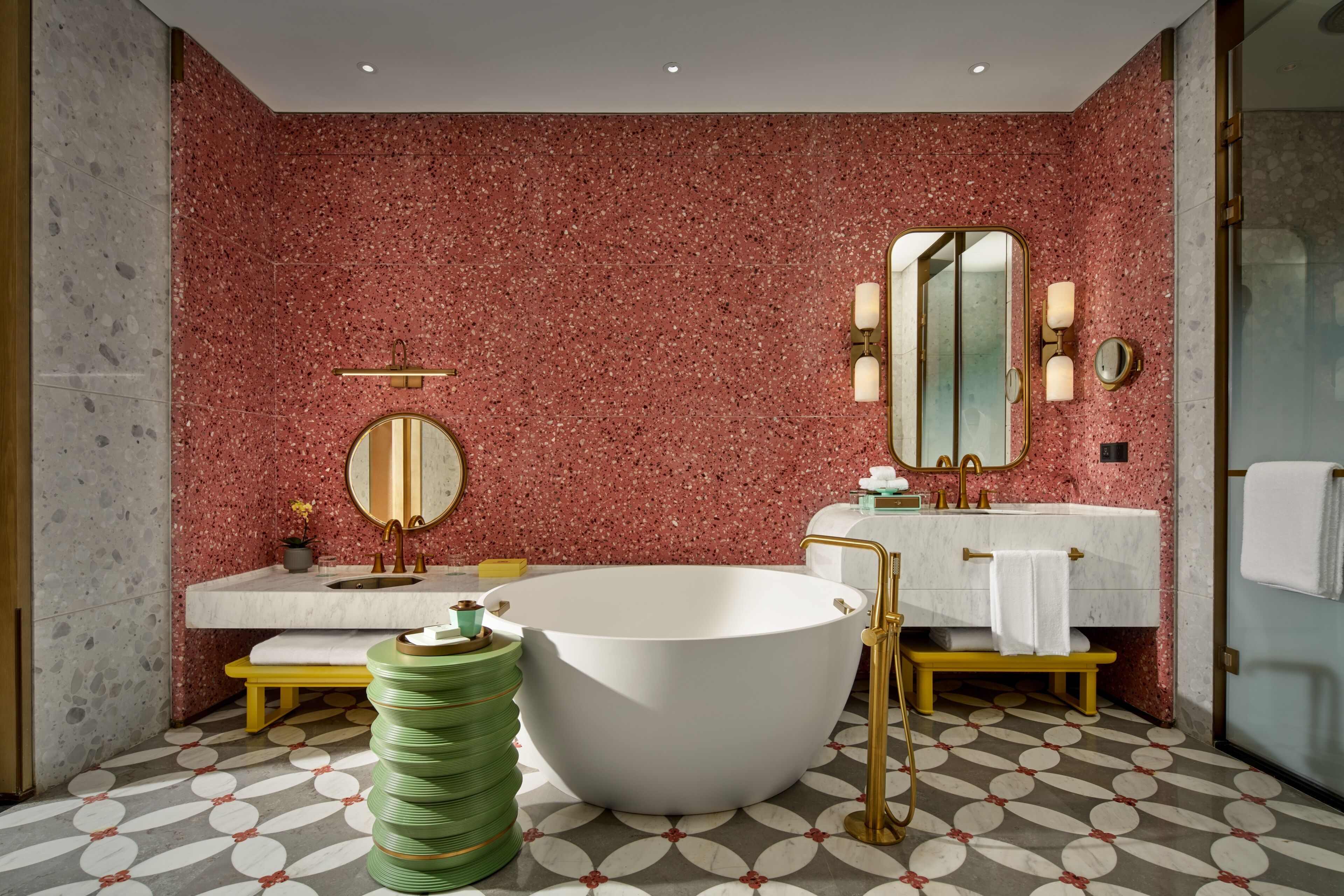 A bathroom with a freestanding bathtub, a vanity with a mirror, and a sink.