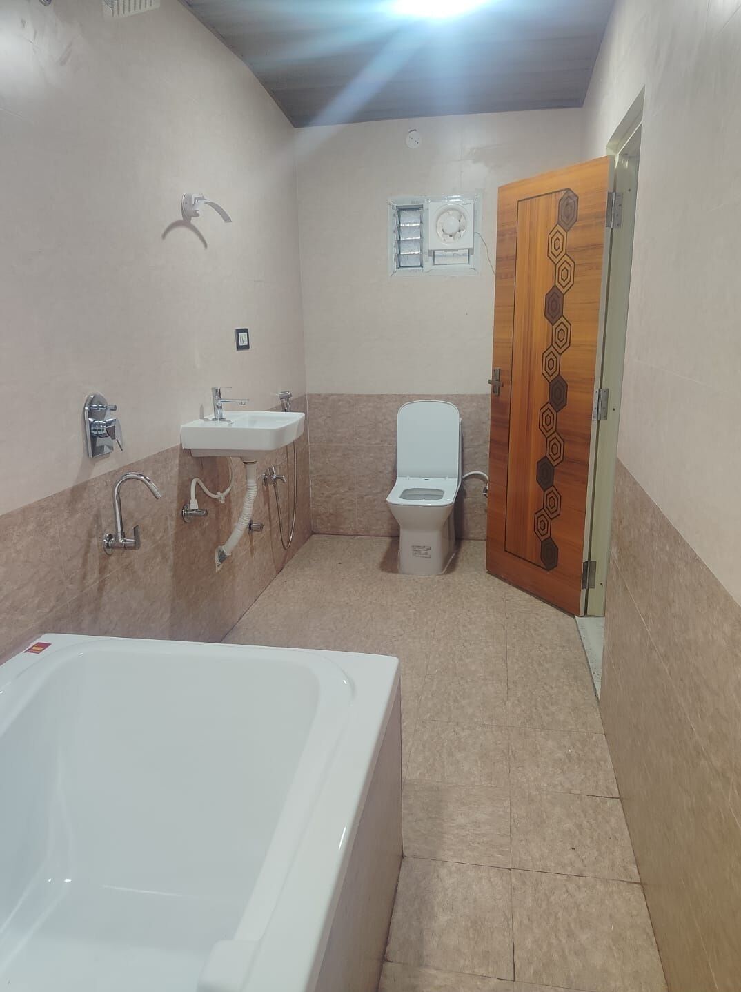 A bathroom with a bathtub, sink, toilet, and shower.