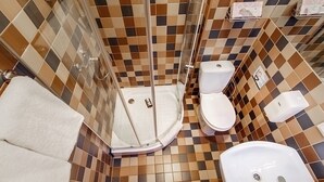 A bathroom with a shower, toilet, and sink. - Double room, small kitchen, 2 persons (Riga)