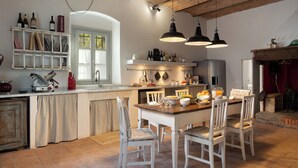 A kitchen with a central island, white chairs, and hanging pendant lights. - Country House / Farm House in Olmi with 5 bedrooms sleeps 10 (Olmi)