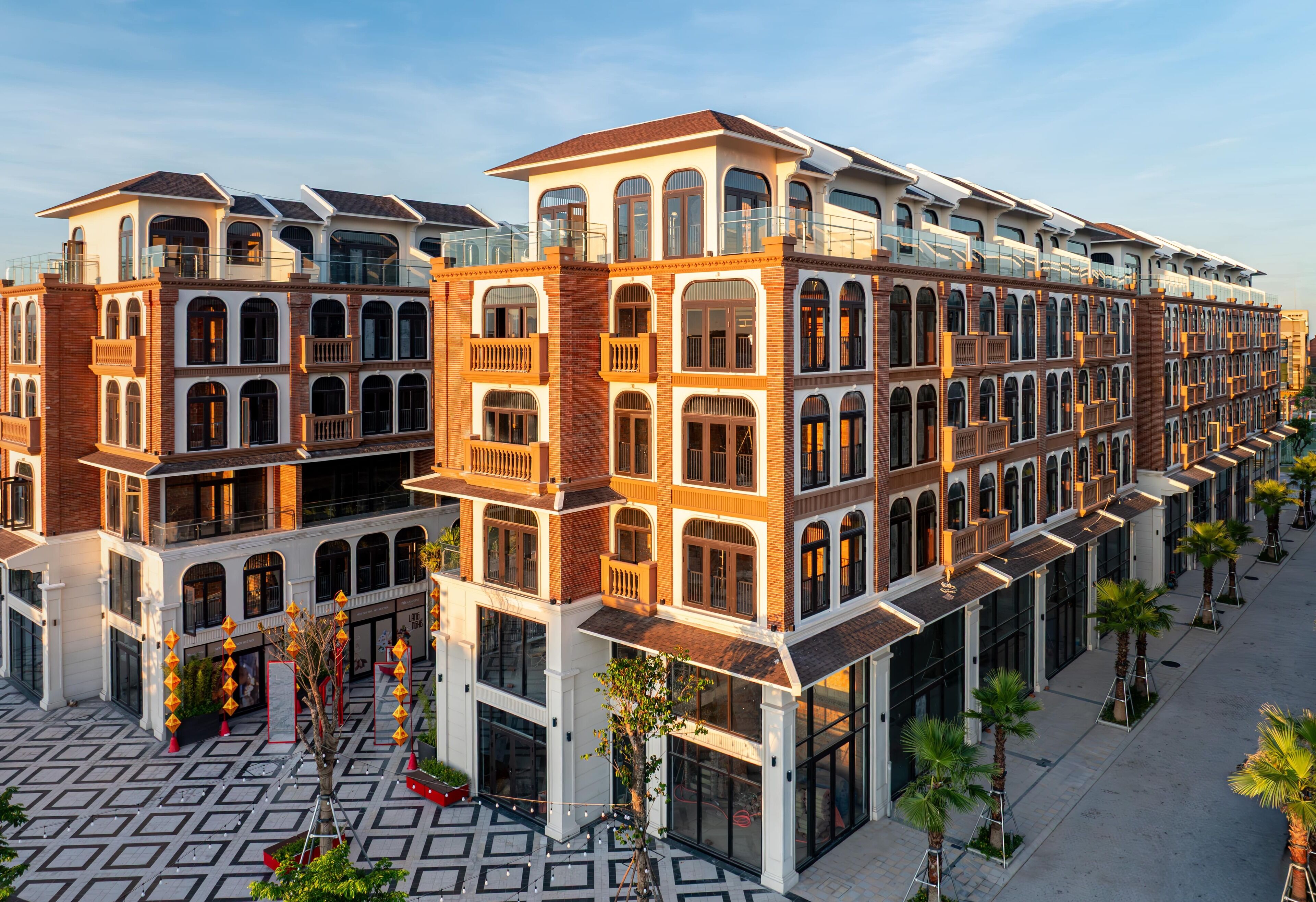 A multi-story hotel with a central courtyard, large windows, and a modern architectural design.