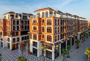 A multi-story hotel with a central courtyard, large windows, and a modern architectural design. - Lumiere Boutique Vy Da (Hue)