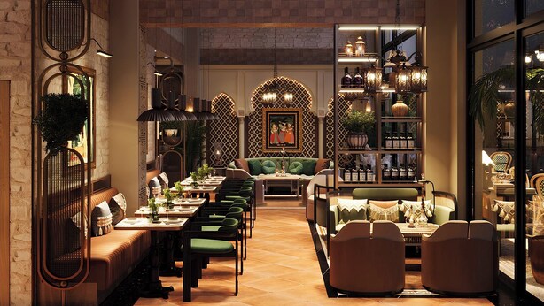 Interior espaçoso e bem iluminado, com uma longa mesa de jantar, assentos confortáveis, objetos decorativos e plantas.