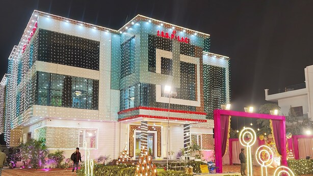 A building with a modern facade, large windows, and a well-lit entrance. - JSB PALACE (Varanasi)