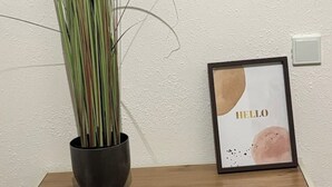 A framed artwork with the word "HELLO" on a textured wall. - Emsquartier 2 (Emsdetten)