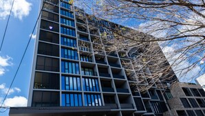 A modern building with multiple floors, large windows, and balconies. - Preston Rooftop Oasis - Pool, Views & City Access (Preston)