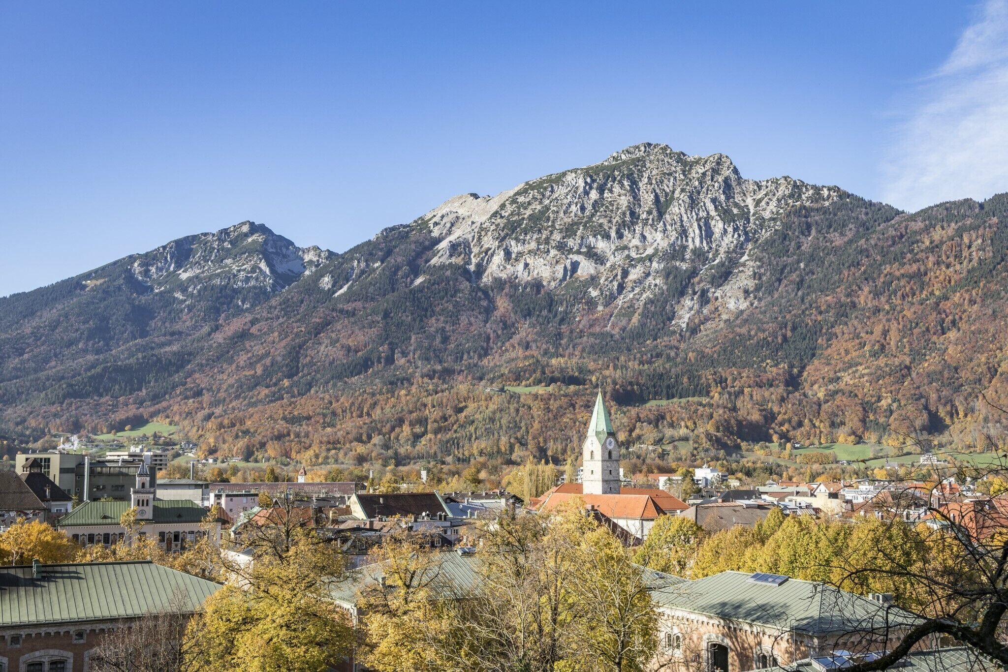 A town with a prominent church and a mountain backdrop.
