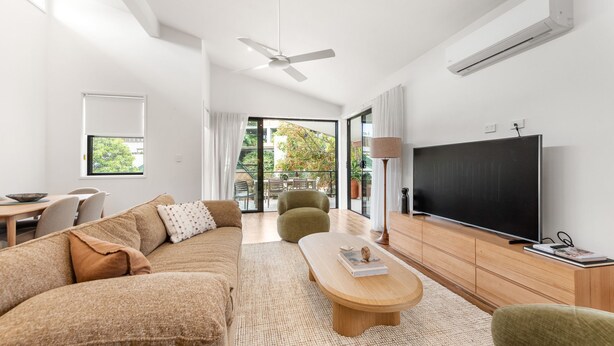 A modern living room with a sofa, coffee table, and television. - Byron Bay Accom - Keesing Villa 8 right in the heart of Byron Bay (Byron Bay)