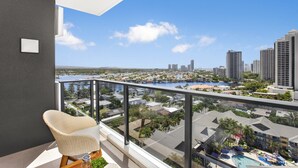 A balcony with a view of a cityscape and a body of water. - 2-Bed Beach Apartment with Pool, Parking & Balcony (Surfers Paradise)