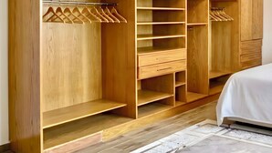 A spacious walk-in closet with multiple shelves, drawers, and hanging space. - Elegant Apartment at Sheikh Zayed Compound (Sheikh Zayed)